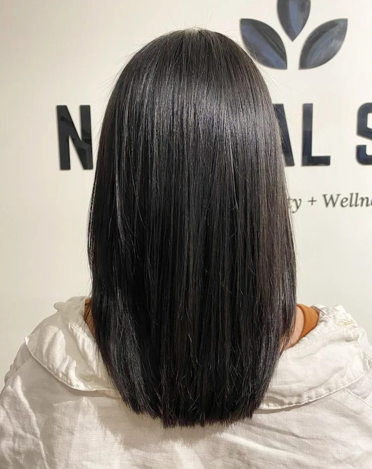 Glossy black hair after an organic shine treatment at Natural Shine Hair & Beauty