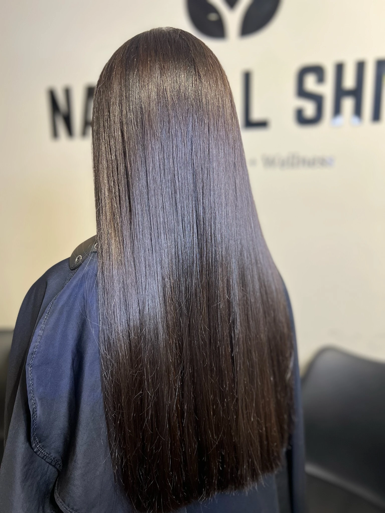 Long dark hair left glossy by a deep-conditioning gloss treatment at Natural Shine Hair & Beauty