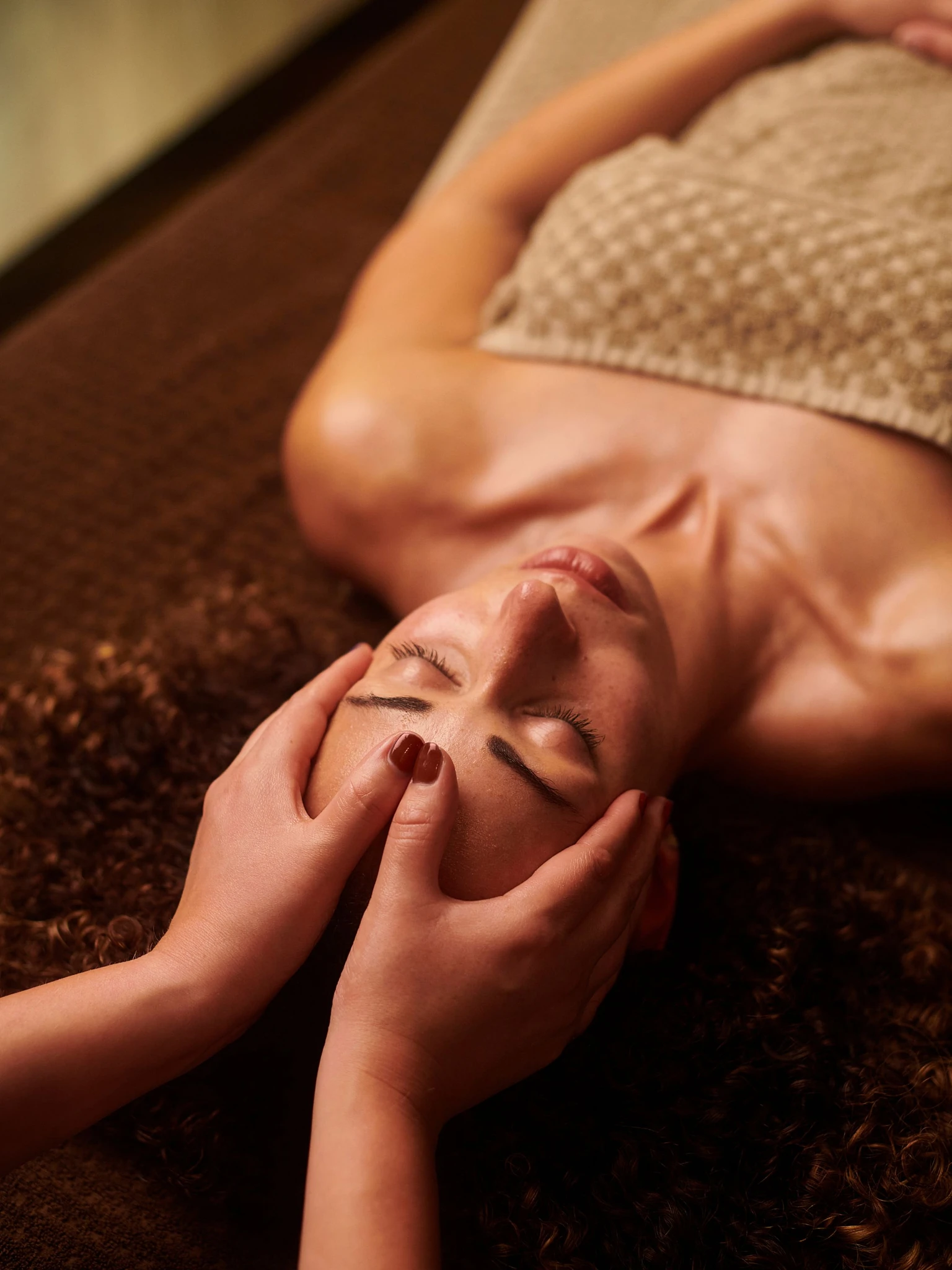 Relaxing head and scalp massage during a wellness treatment at Natural Shine Hair & Beauty
